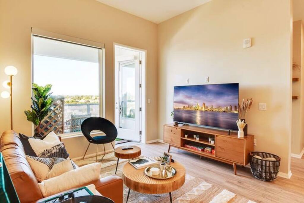 [Living Room] - 65" smart TV w/ Netflix, board games, cards, blanket, table lamp, genuine leather couch, accent chair